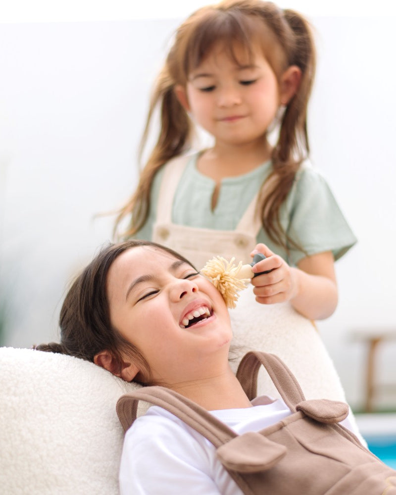 Child playing with PlanToys My Spa Time wooden pretend play spa accessories