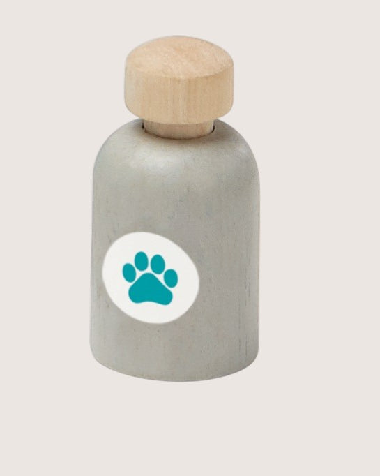 Bottle with wooden cap and paw print label on a light gray background