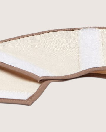 Folded beige and white fabric on a light beige background