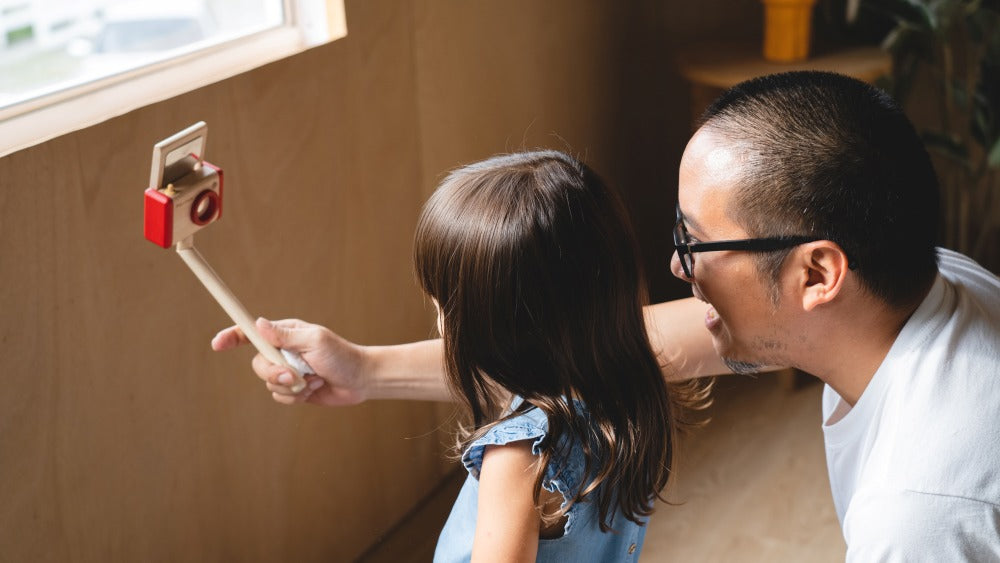 Child playing content creator with PlanToys wooden vlogger equipment