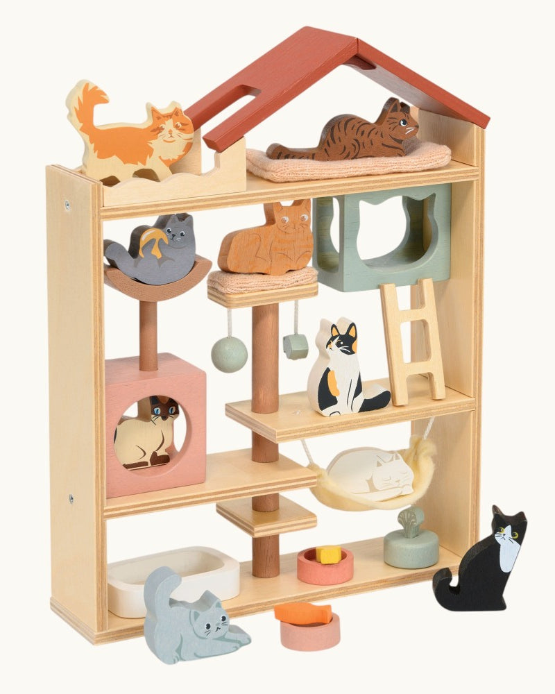 Wooden pet playhouse with shelves and cat-shaped toys on a white background