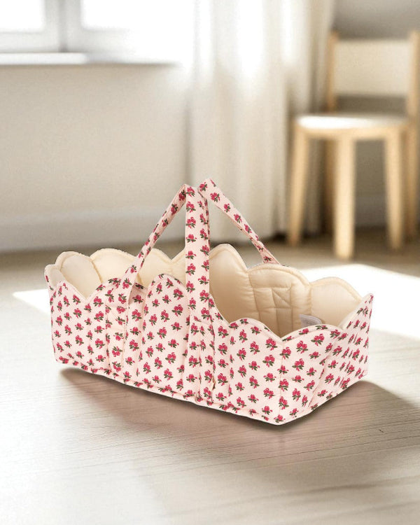 Full Rosie Rose doll bassinet with vintage floral exterior, cream quilted interior lining and sturdy carrying handles