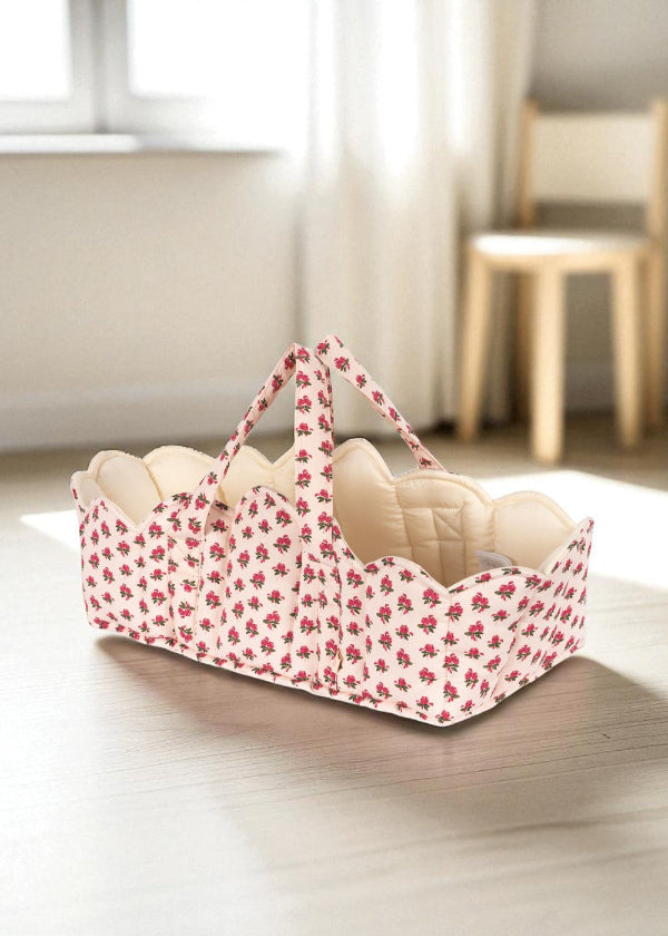 Full Rosie Rose doll bassinet with vintage floral exterior, cream quilted interior lining and sturdy carrying handles