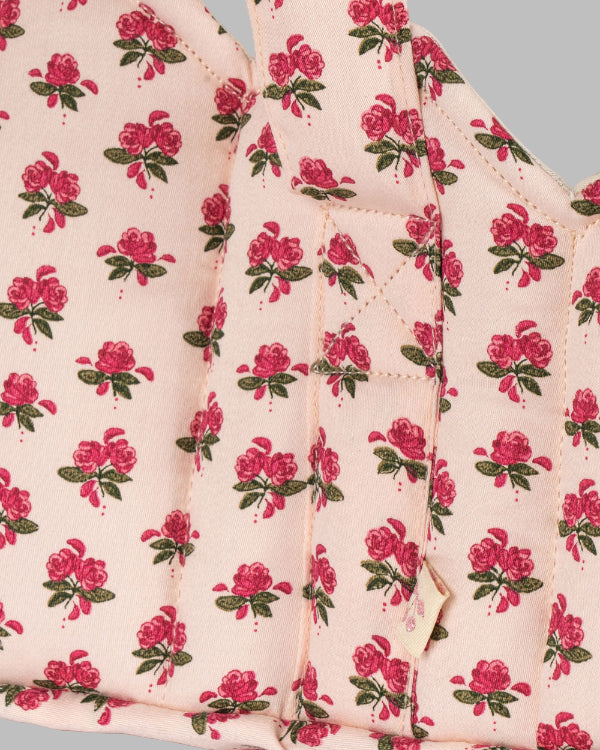 Close-up of Rosie Rose print fabric showing delicate pink roses with green leaves pattern and premium cotton construction detail