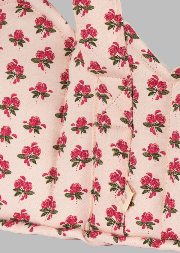 Close-up of Rosie Rose print fabric showing delicate pink roses with green leaves pattern and premium cotton construction detail