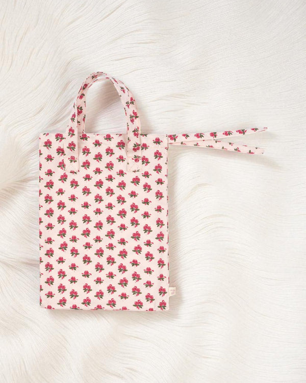 Floral-patterned tote bag on a textured white surface