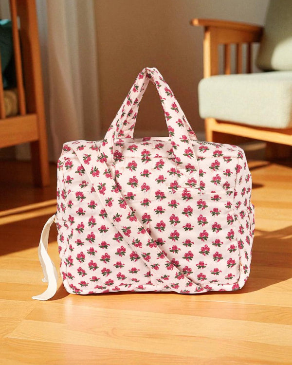 Rosie Rose doll diaper bag with vintage pink rose print, dual handles and shoulder strap on wooden floor