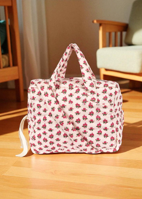 Rosie Rose doll diaper bag with vintage pink rose print, dual handles and shoulder strap on wooden floor