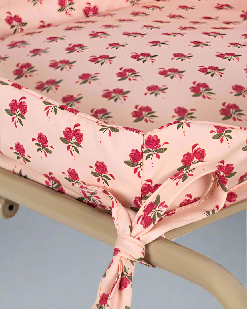 Premium fabric seat showing branded label accent and rose pattern detail on champagne wire basket frame