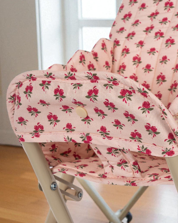 Close-up of quilted rose print cushion showing delicate pink roses with green leaves pattern and premium cotton construction