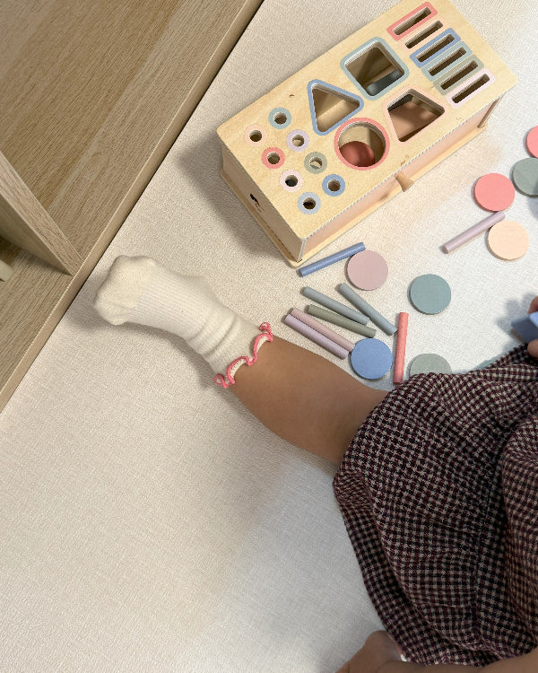 Little feet in anti-slip socks walking safely on smooth indoor surfaces