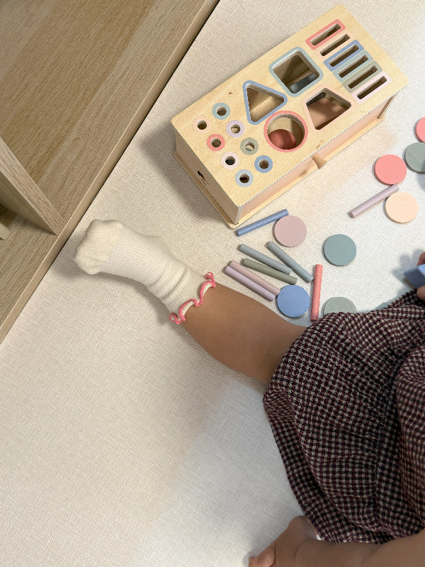 Little feet in anti-slip socks walking safely on smooth indoor surfaces