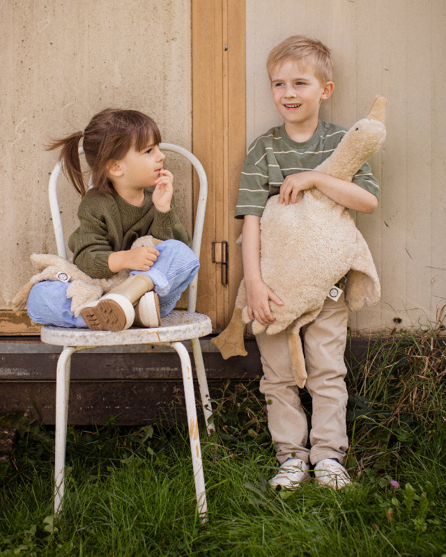 Large 31-inch Senger goose in cream being cuddled by preschool-aged child