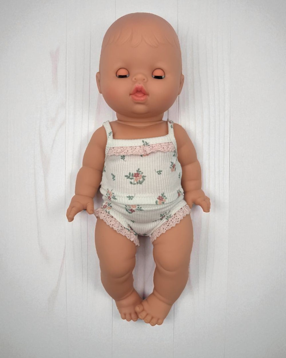 European baby girl doll with sleeping eyes Minikane articulated hard body doll