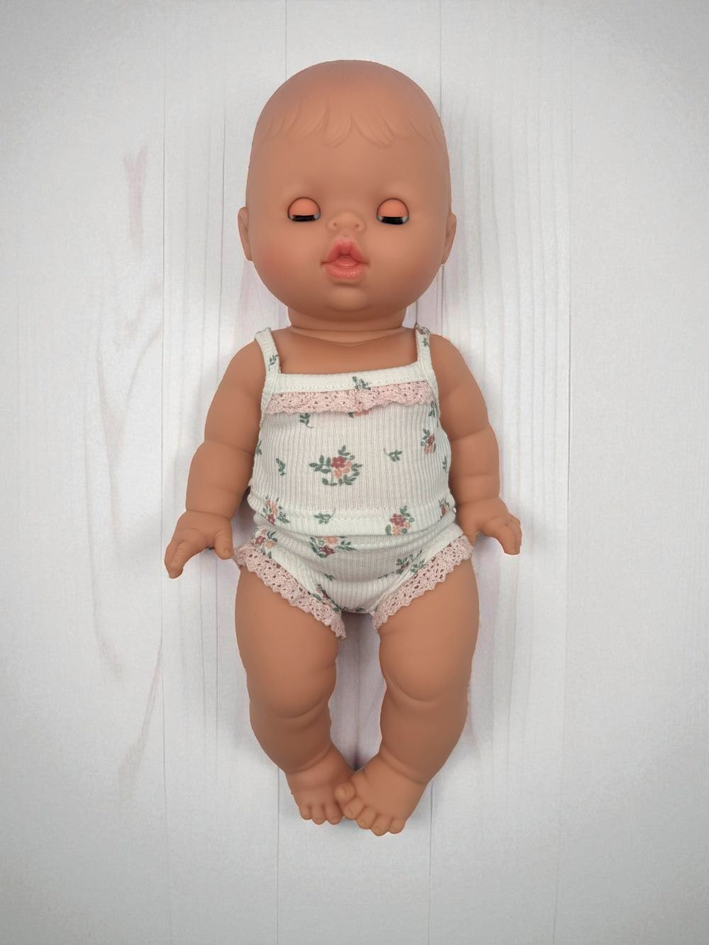 European baby girl doll with sleeping eyes Minikane articulated hard body doll