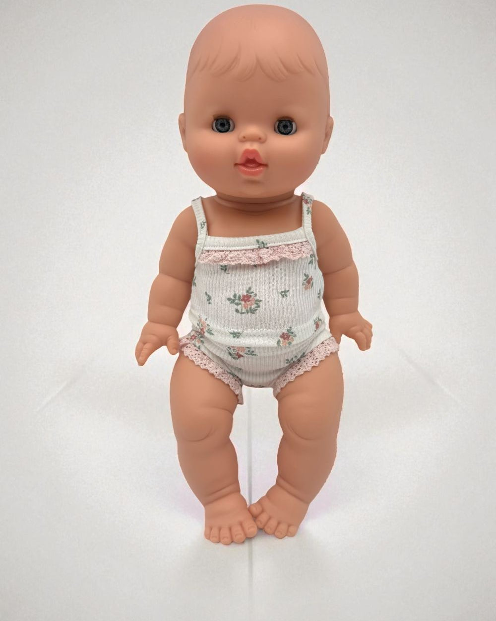 Sleepy baby girl doll closing eyes feature Minikane 13 inch premium vinyl construction