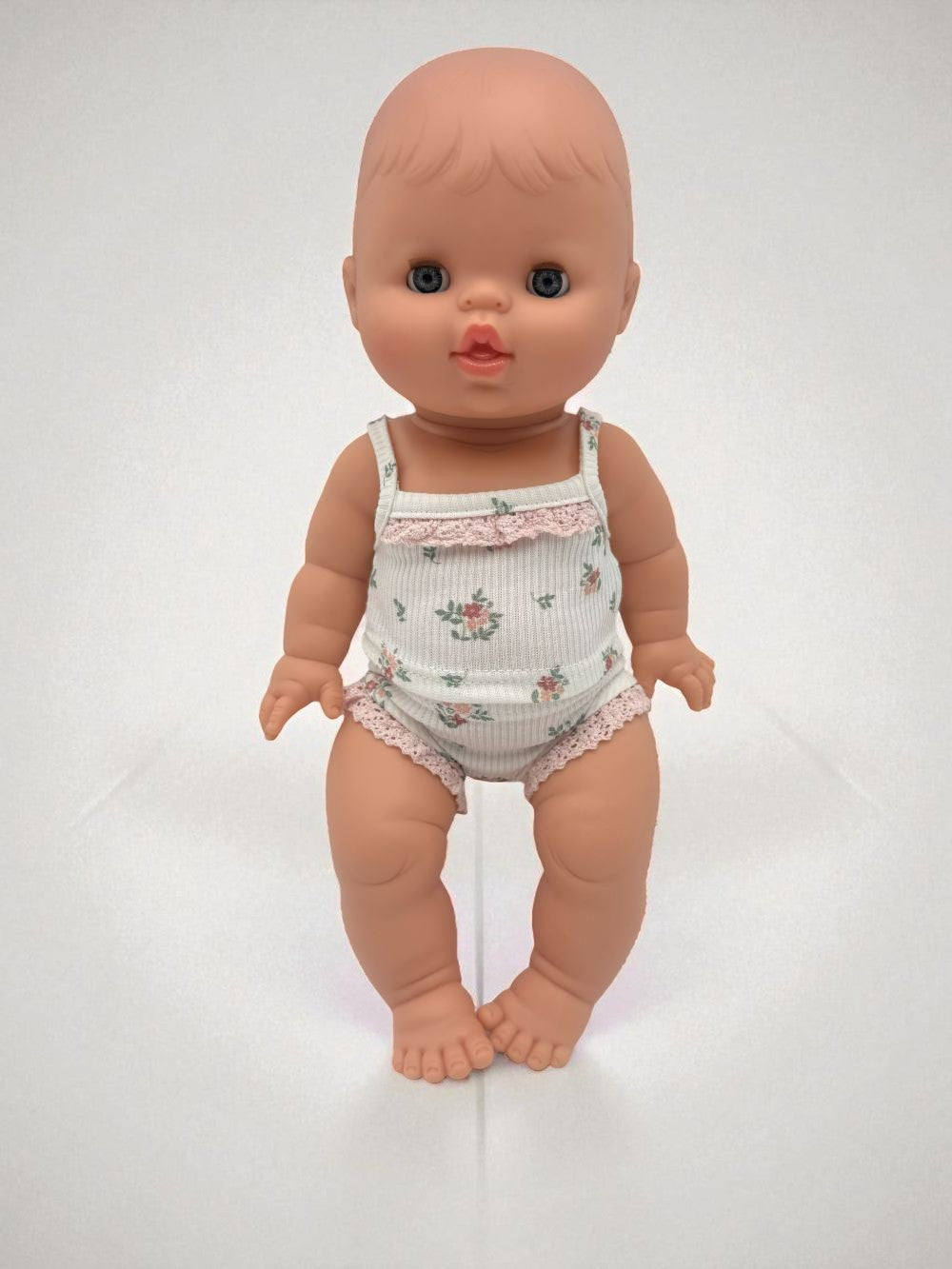 Sleepy baby girl doll closing eyes feature Minikane 13 inch premium vinyl construction