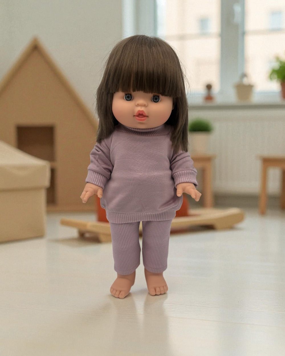 14-inch standing Minikane Chloe doll with modern dark bob and bright blue eyes