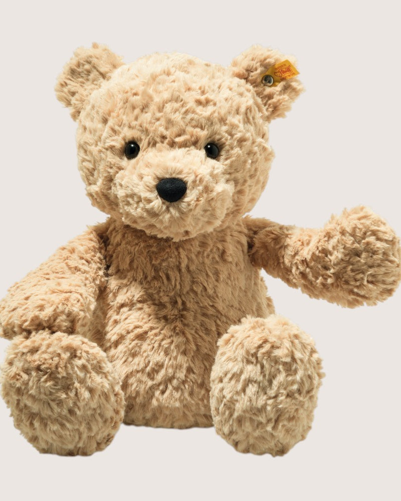 Beige teddy bear on a light gray background