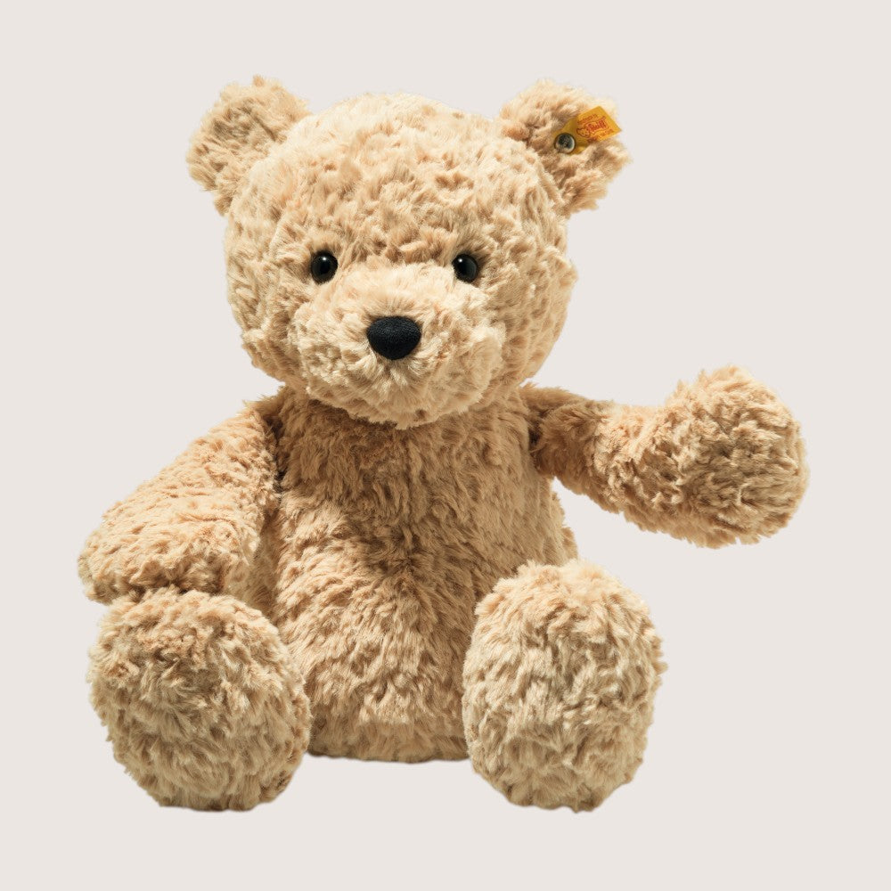 Beige teddy bear on a light gray background