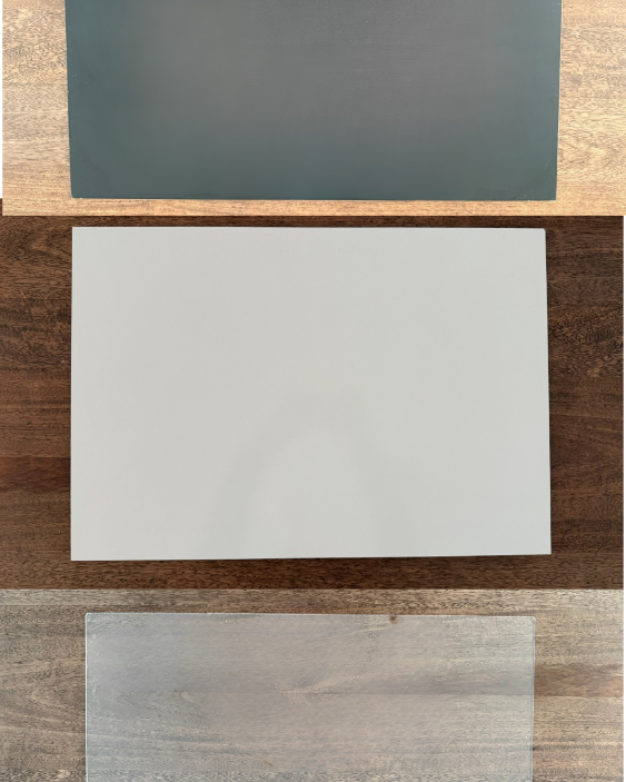 Three different easel surfaces on a wooden surface