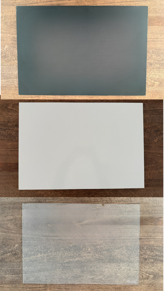 Three different easel surfaces on a wooden surface
