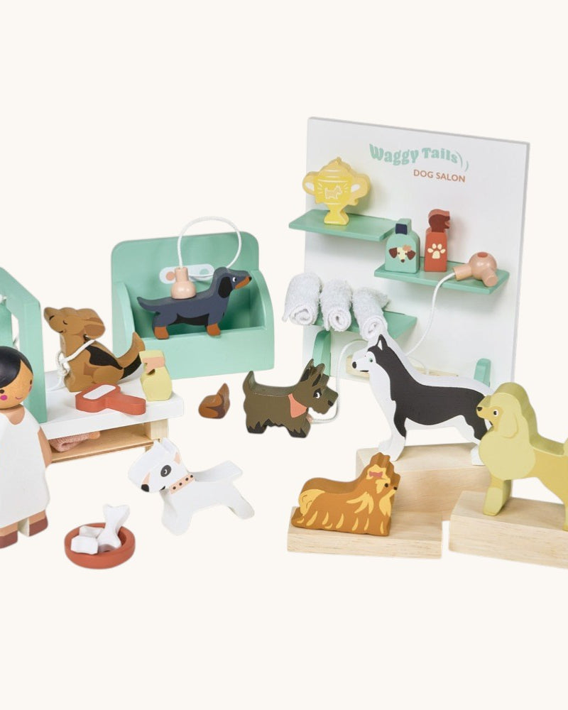 Wooden toy set with dogs and a vet, including a display stand with 'Waggy Tales' branding.