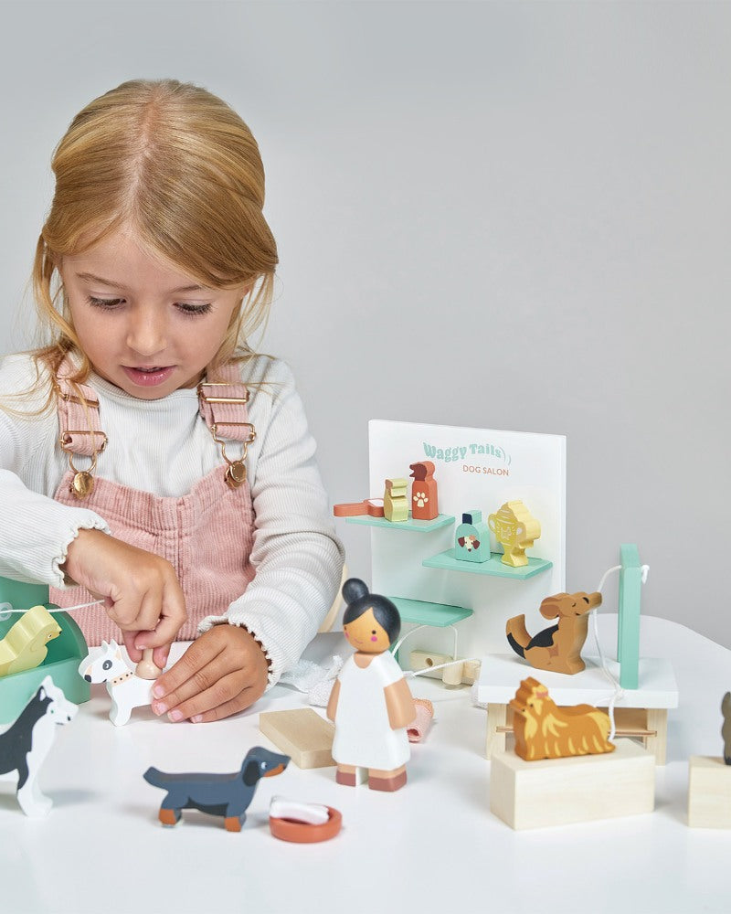 Child playing with wooden toys on a white surface