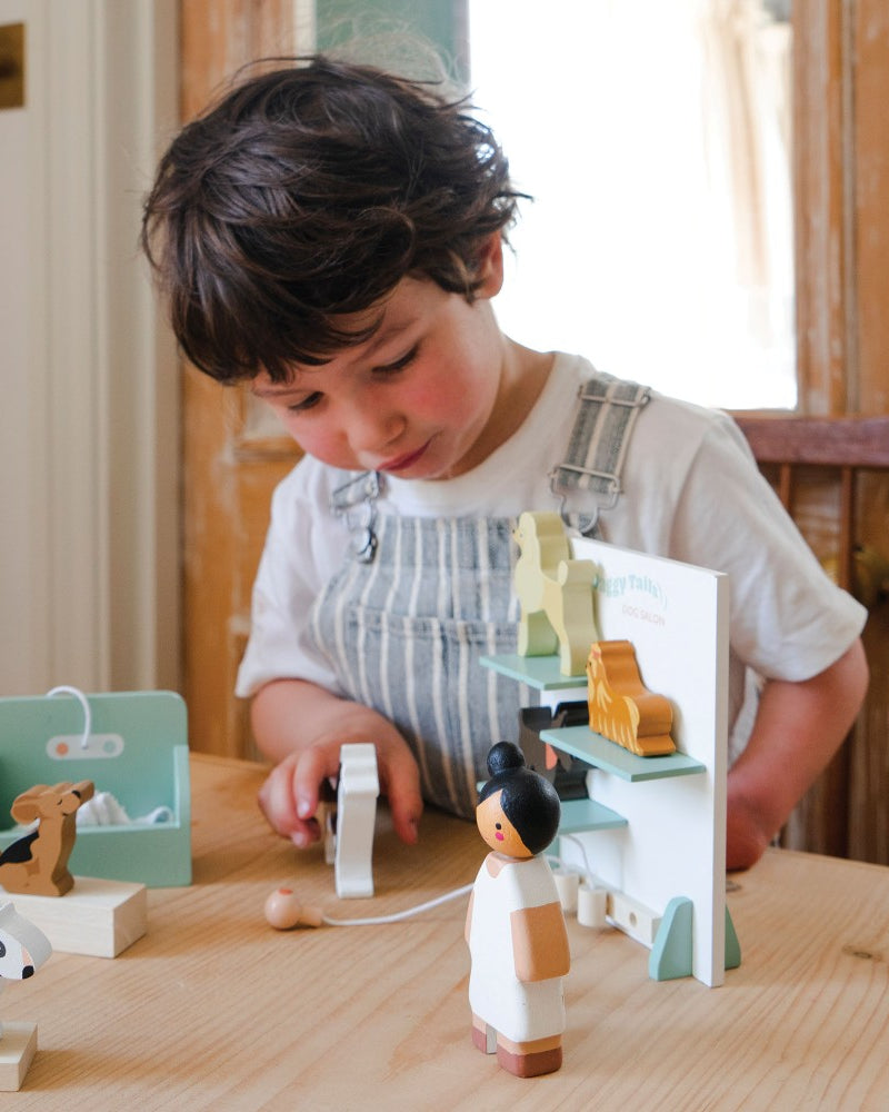 Child playing with wooden toys on a table