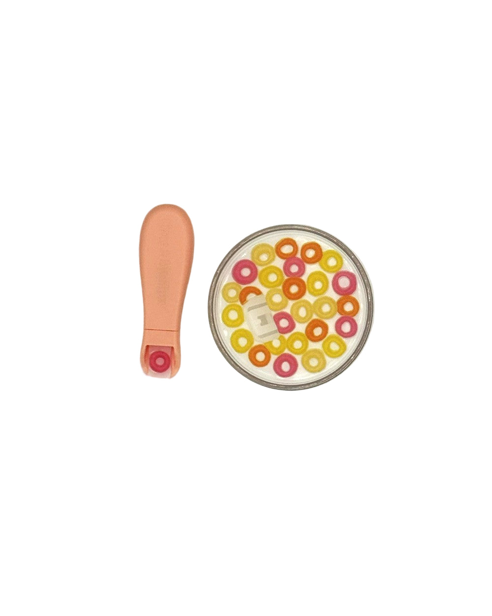 Close-up of BPA-free plastic construction and realistic colorful cereal loops with milk in clear bowl