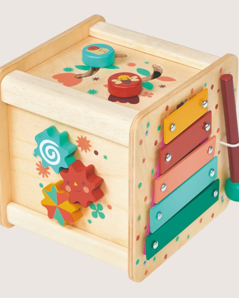 Colorful wooden toy with various interactive elements on a light gray background