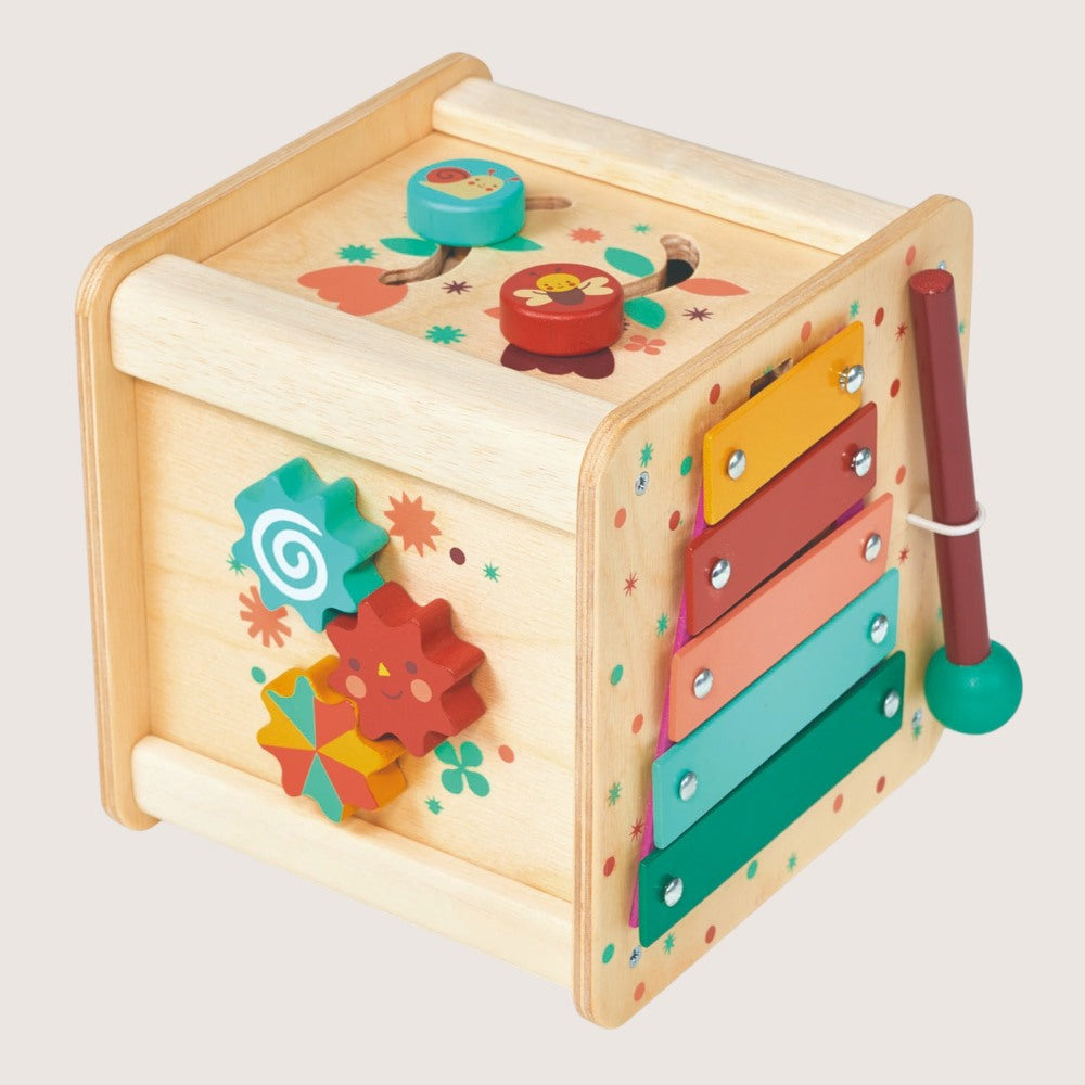 Colorful wooden toy with various interactive elements on a light gray background