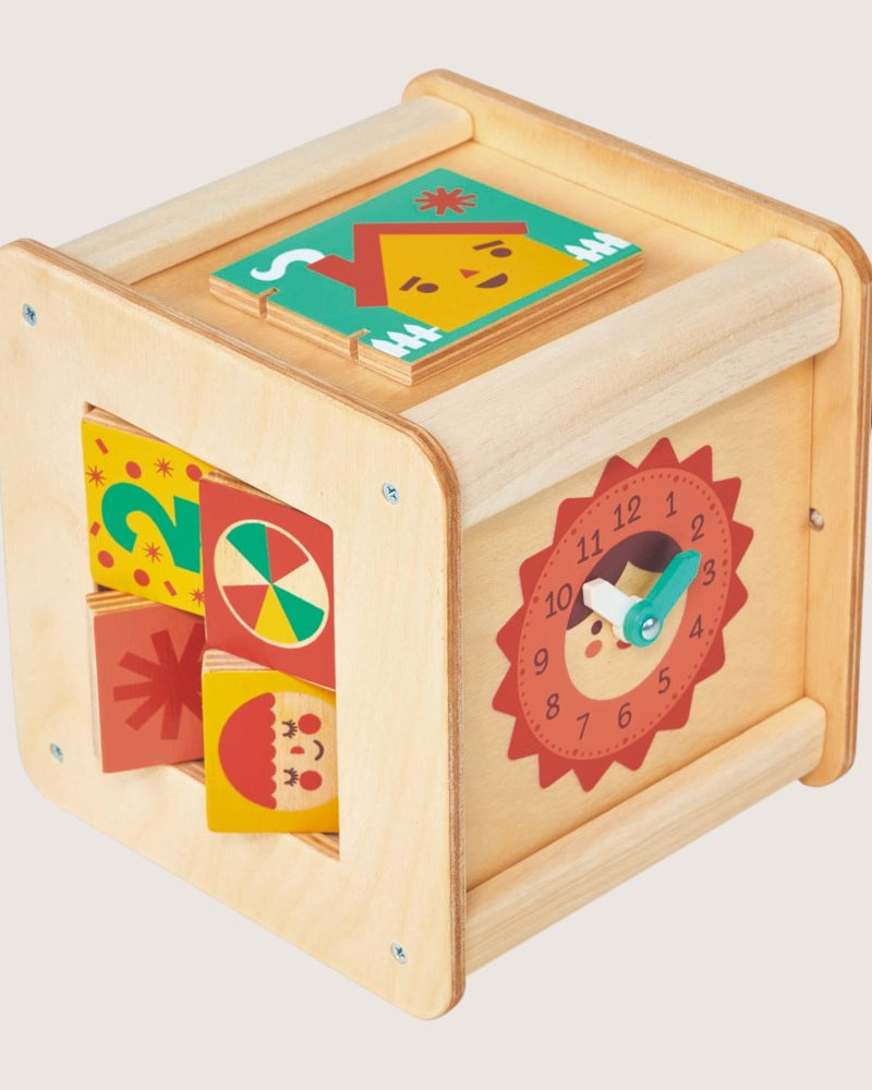 Wooden educational toy with colorful geometric shapes and a clock face on a light gray background