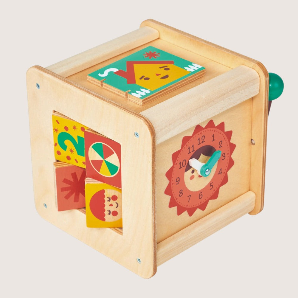 Wooden educational toy with colorful geometric shapes and a clock face on a light gray background