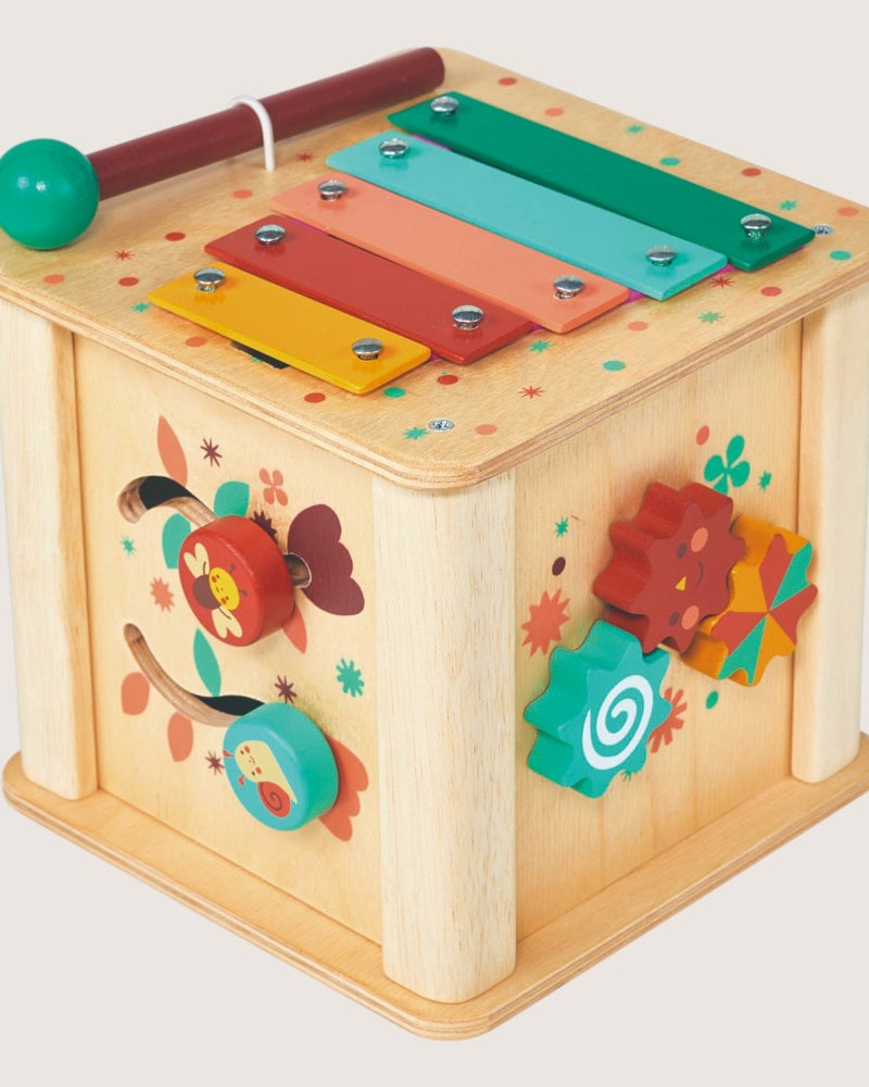 Colorful wooden toy with various interactive elements on a light background