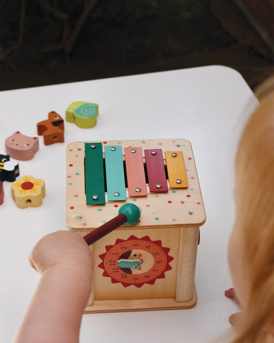 Child playing with Mentari multi-activity cube exploring different learning sides