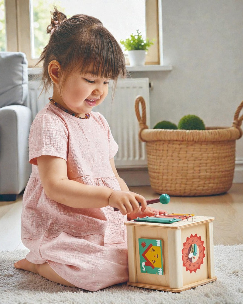 Close-up of Mentari activity cube showing colorful gears and interactive features