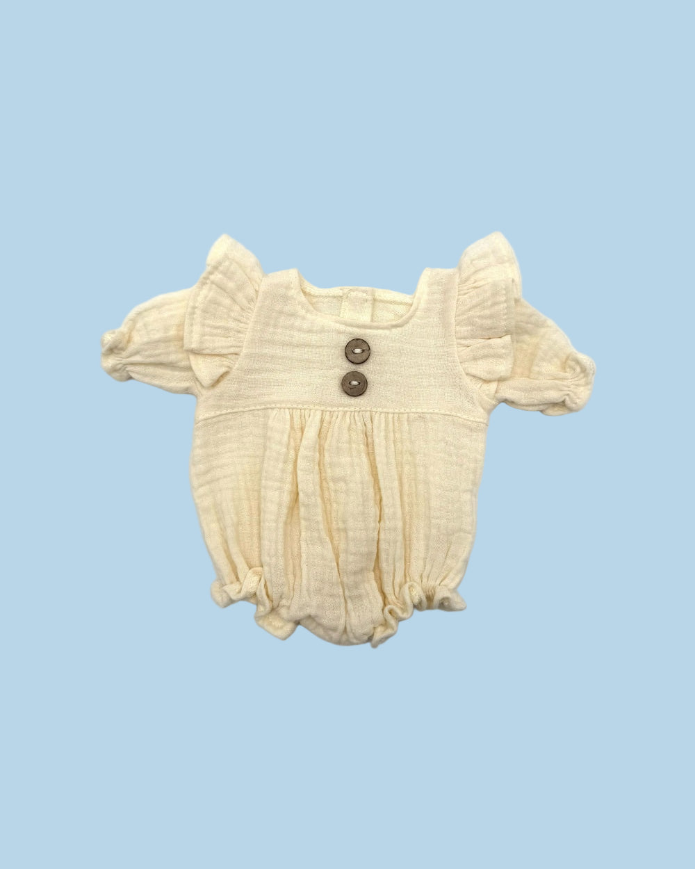 Cotton muslin one-piece romper with vintage button detail and easy velcro back closure