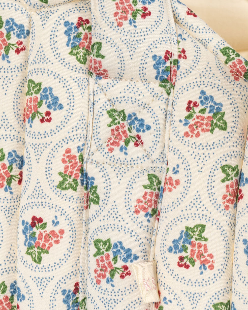 Close-up of Verona Blues print showing cornflower blue flowers, coral blooms, cherries and dotted circle details