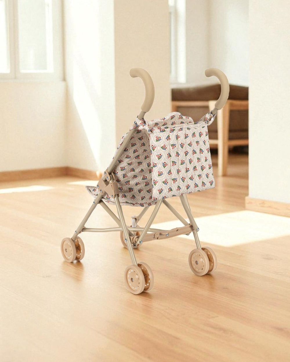 Full view of cream-colored doll stroller in Verona Blues pattern with storage basket