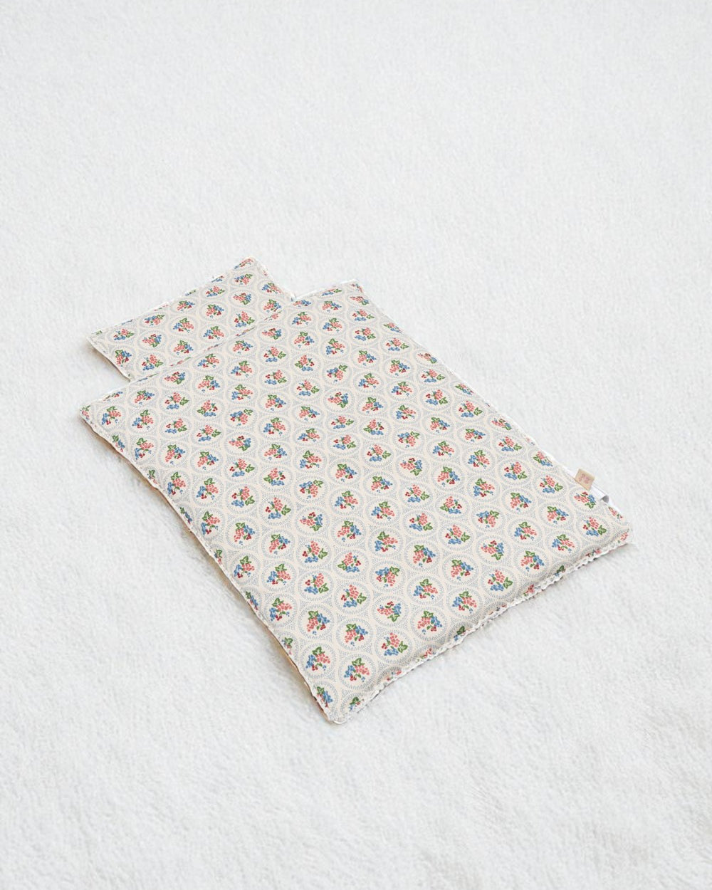 Verona Blues bedding set with Italian-inspired floral print blanket and pillow arranged together showing coordinated Mediterranean design