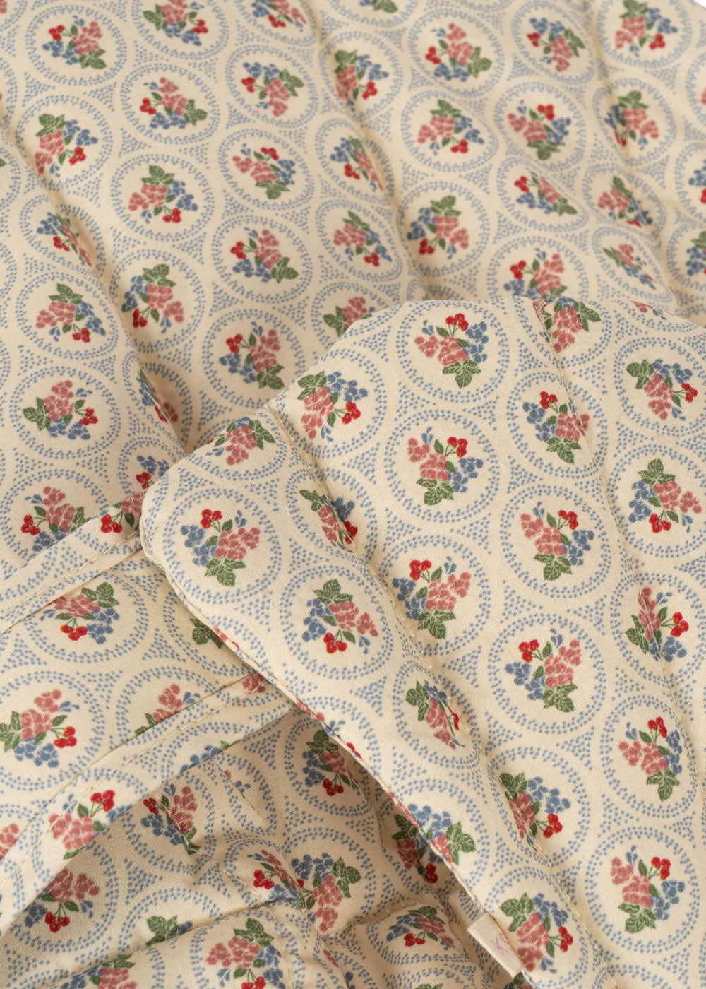Close-up of Verona Blues print showing cornflower blue flowers with coral, cherry and green accents and dotted circle details