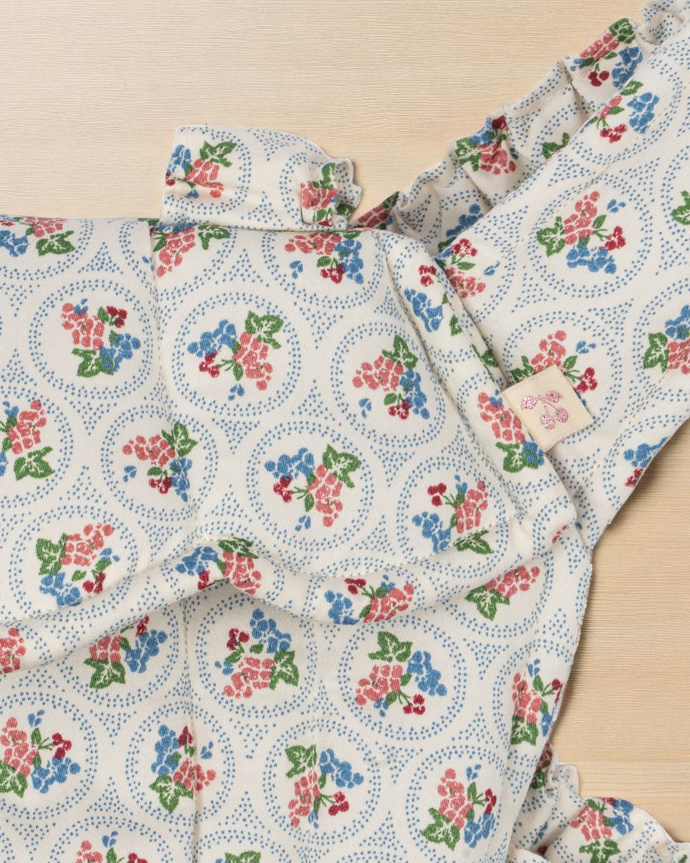 Close-up of Verona Blues print showing cornflower blue flowers, coral blooms, cherries and dotted circle details