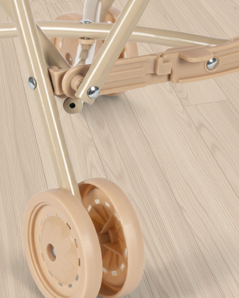 Close-up of a beige dolly with wheels on a wooden floor
