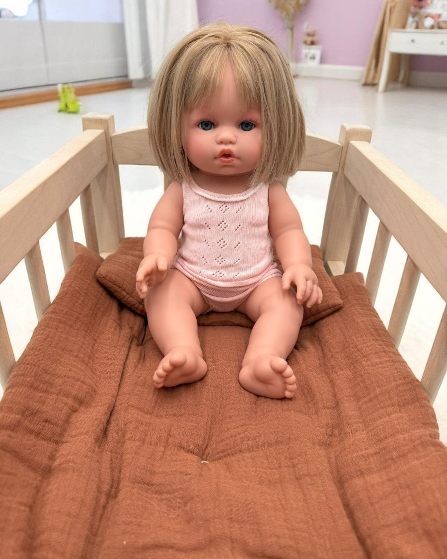 Realistic doll Vienna with silky blonde straight hair and pink pajamas for quality pretend play