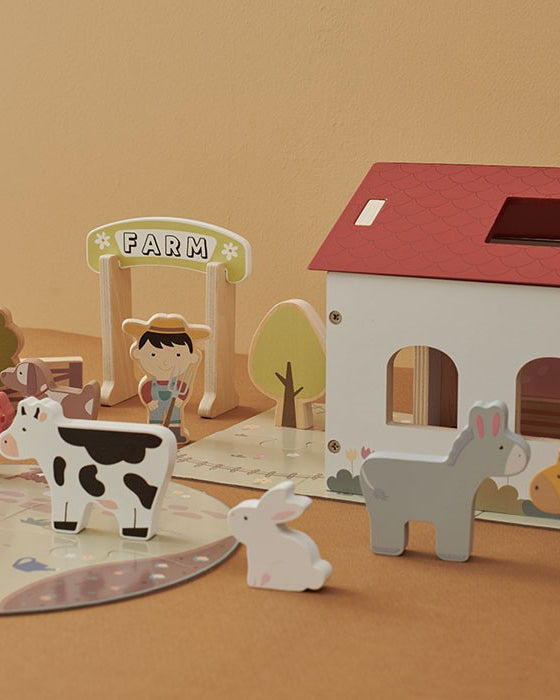 Detail shots showing smooth non-toxic wood finish on animal figures and neat painted shingle pattern on farmhouse roof