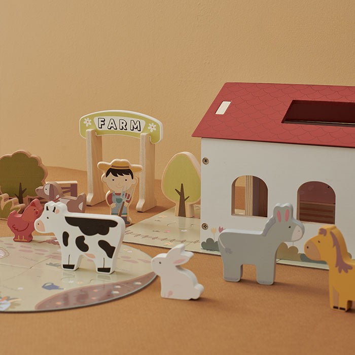 Detail shots showing smooth non-toxic wood finish on animal figures and neat painted shingle pattern on farmhouse roof