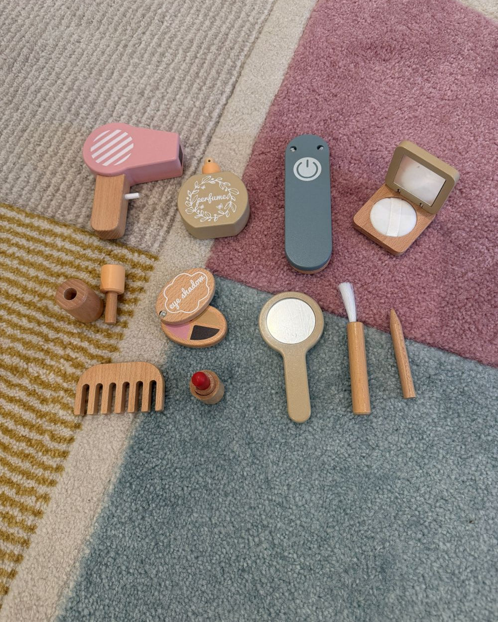 Set of wooden makeup toys on a textured surface