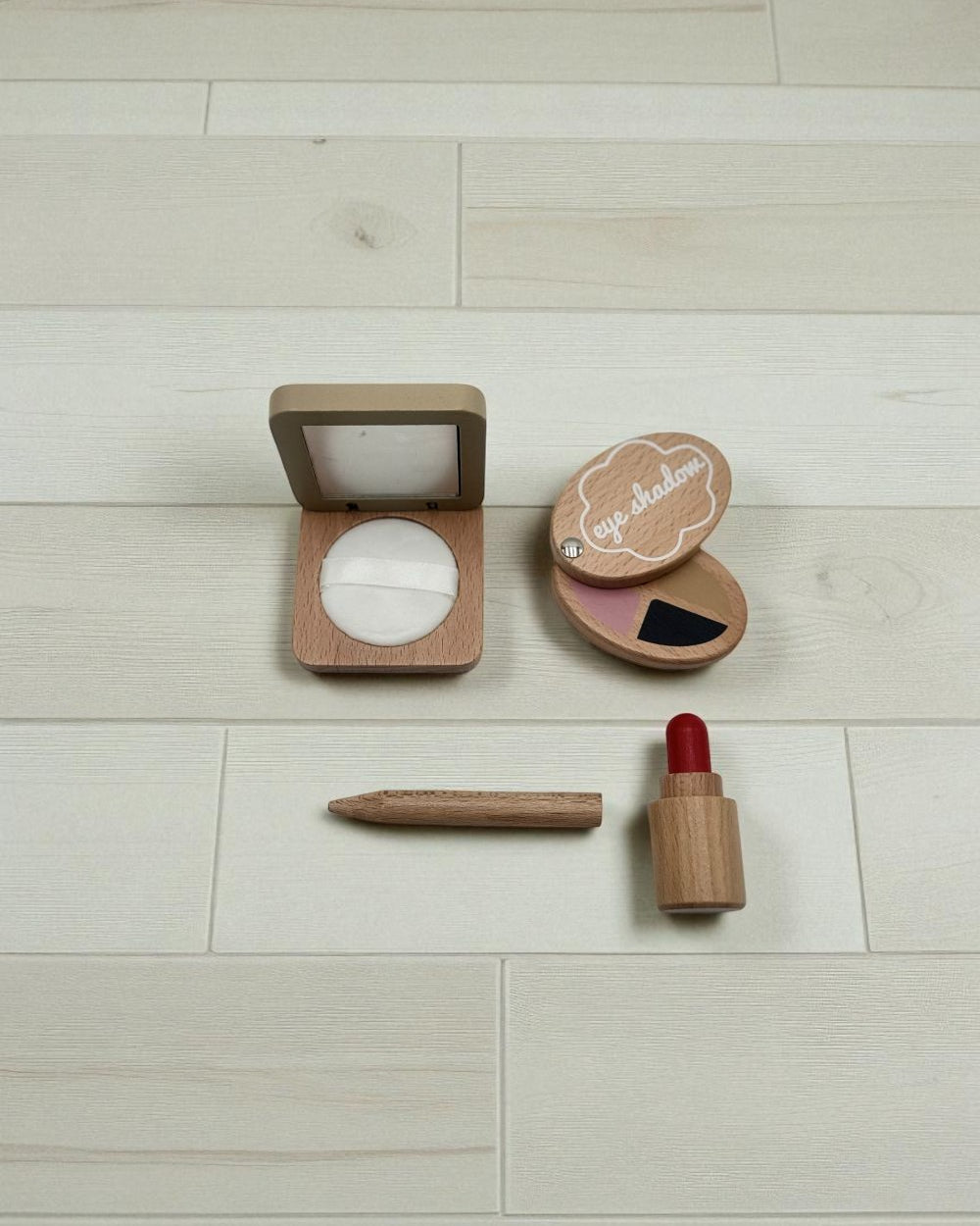 Compact, eye shadow, eyeliner and lipstick