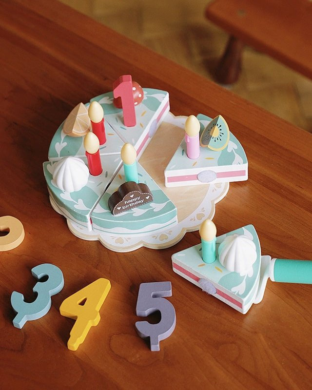 Complete wooden birthday cake Montessori playset showing all decorative elements and accessories